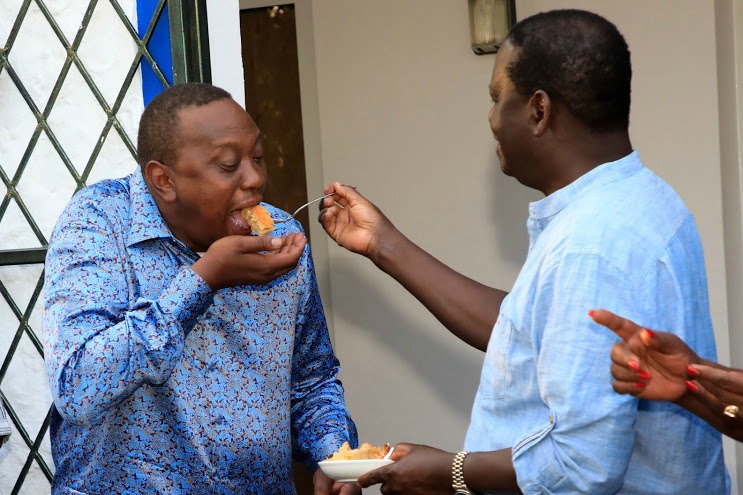 Raila giving Uhuru cake