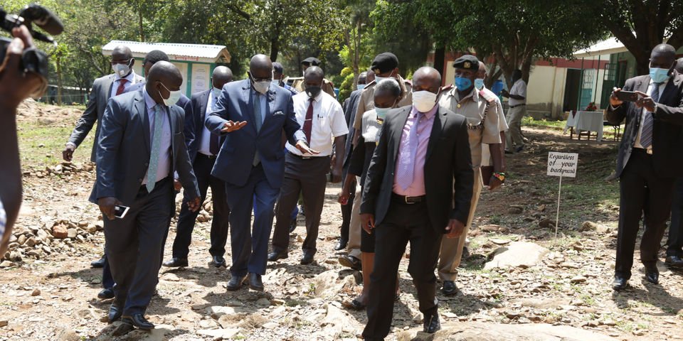 CS George Magoha while in Kisumu County. The bodyguard accused of sexually harassing a journalist is in a purple shirt. 