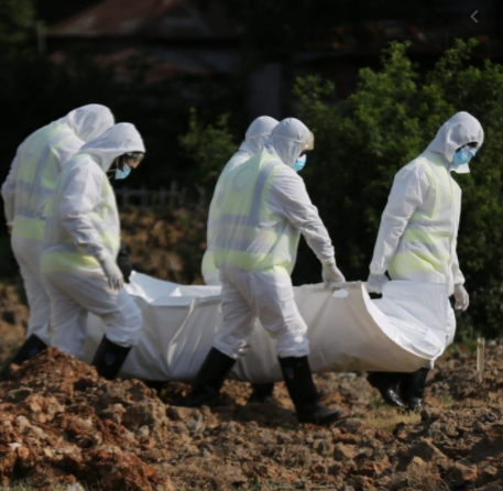 Health officials carrying dead body