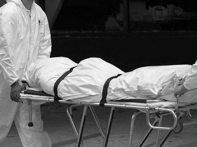 Medics taking away dead body