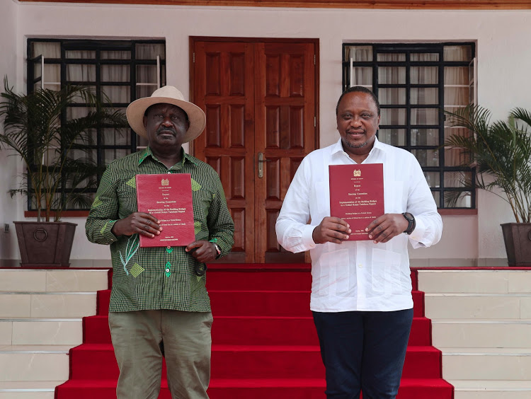 President Uhuru Kenyatta and ODM Leader Raila Odinga hold copies of the BBI bill at the Kisii State Lodge. 