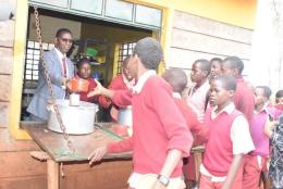 Ruiru MP Simon King'ara serves lunch to Ruiru Primary School pupils in October 2019. |Photo| Courtesy|