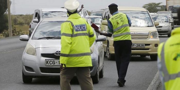 Traffic police officers stop motorist at a check point. |Photo| Courtesy|