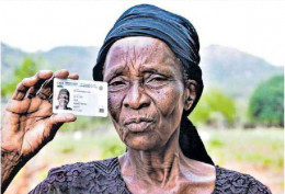 Kamene Katunduma holds up the Huduma Namba card of his missing brother Benjamin Malii Livu. |Photo| Courtesy|