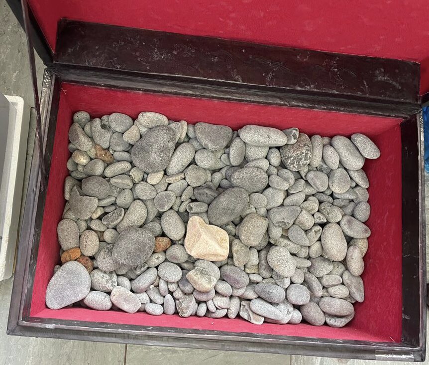 River pebbles neatly arranged in a consignment box recovered by DCI at JKIA. |Courtesy| Twitter|