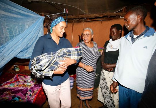 File image of Ngina Kenyatta holding a baby in the company of First Lady Margaret Kenyatta . |Photo| Courtesy|