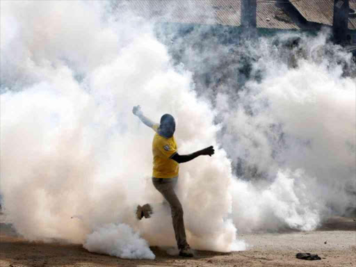 File image of a protester escaping a teargas cloud. |Photo| Courtesy|
