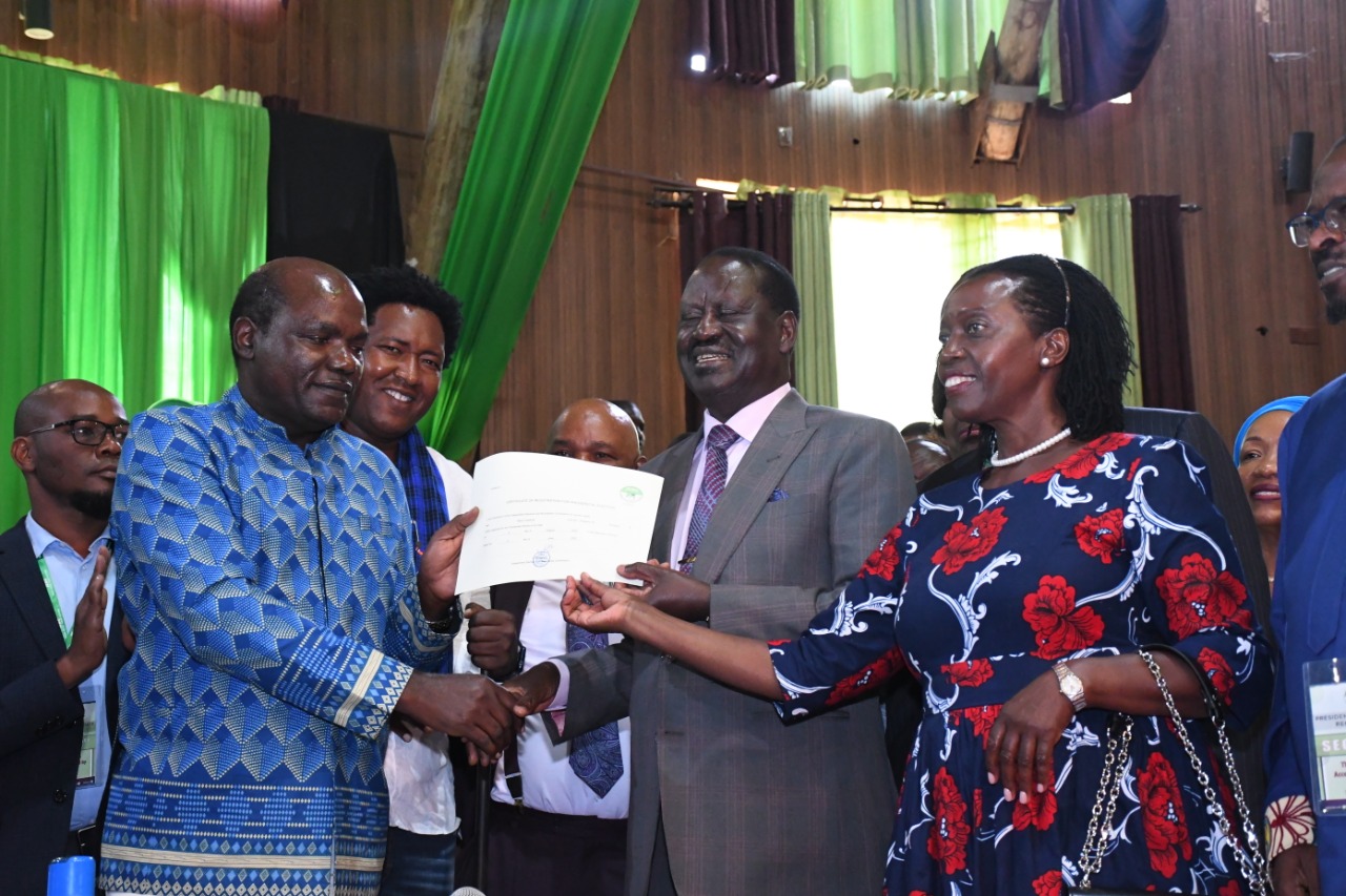 Raila Odinga, Martha Karua and Wafula Chebukati pose for a photo after being cleared by IEBC. 