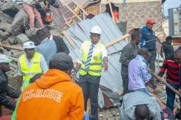 Governor Kimani Wamatangi at the scene of the collapsed building helping in the rescue operations.