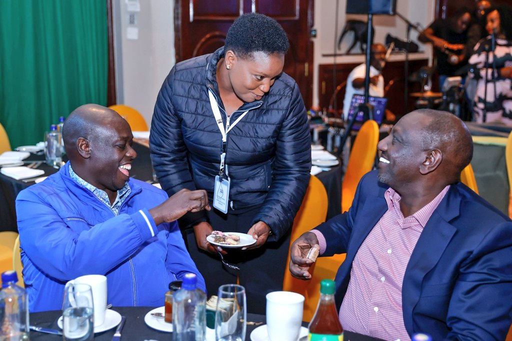 Health CS Susan Nakhumicha gives cake to President William Ruto and his deputy Rigathi Gachagua.