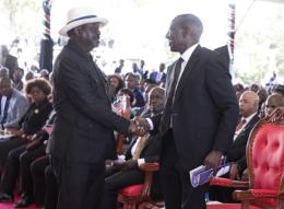 ODM leader Raila Odinga shakes hands With President William Ruto at Mama Mukami Kimathi's burial.