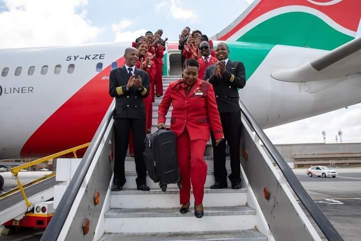 Flight Purser Alice Waweru walks through a guard of honour mounted for her as she sends a KQ plane.