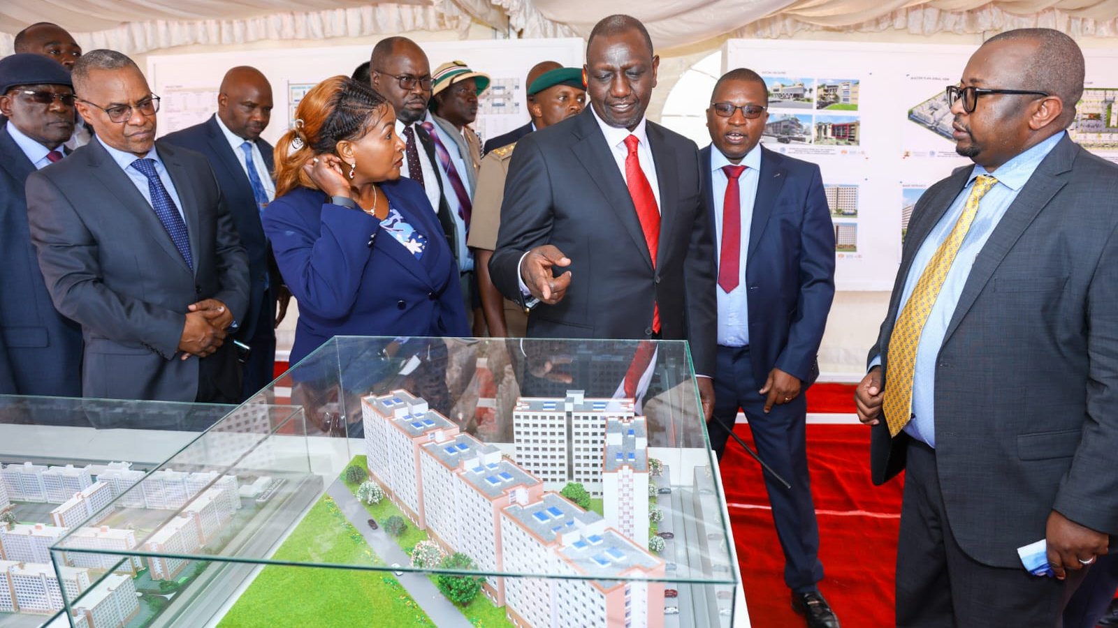 President Ruto observing a model of the Housing Project.