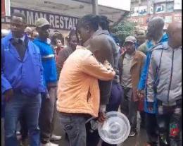 Hawker Weeps after his stock of groundnut was poured.
