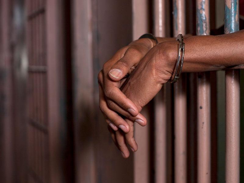 File image of a person in handcuffs.