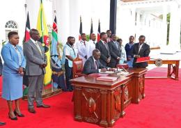 File image of President William Ruto signing UHC bills into law in 2023.