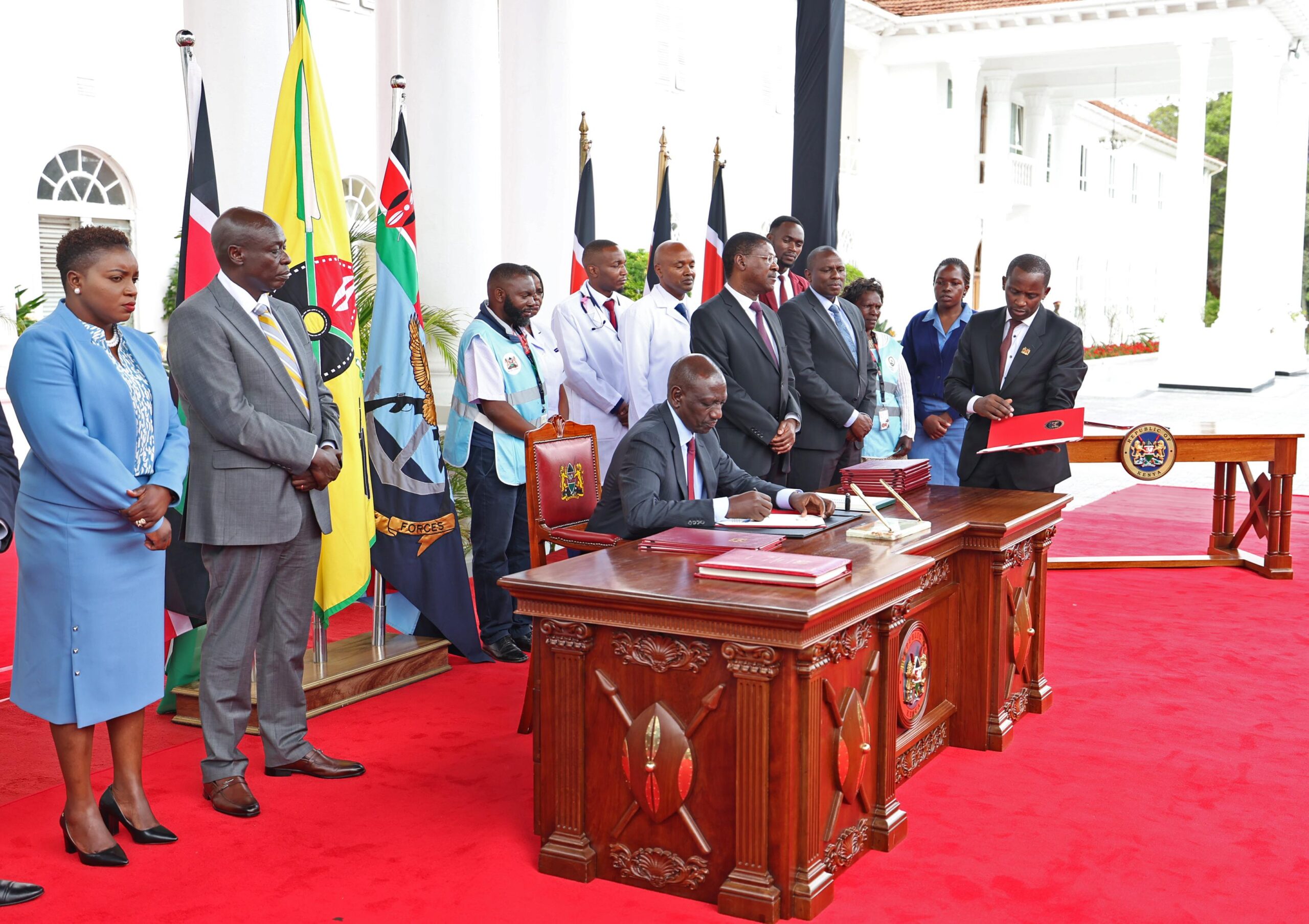 File image of President William Ruto signing UHC bills into law in 2023.