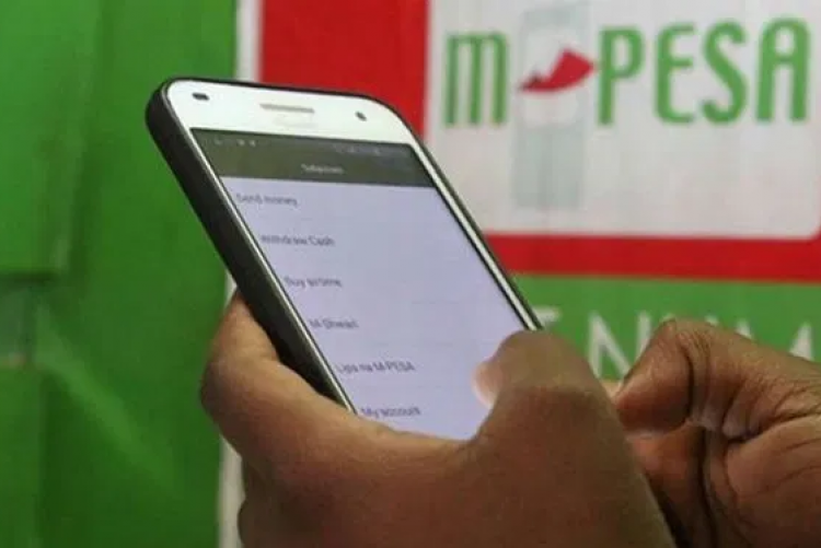 File image of a Safaricom customer using M-Pesa service.