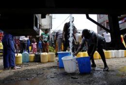 File image of people lining to fetch water.