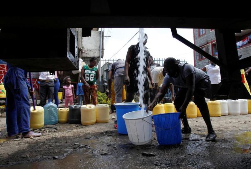 File image of people lining to fetch water.