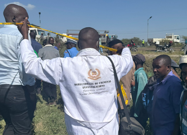 Police officers at the scene where a body of a man was discovered along Mombasa Road.