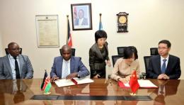 Treasury CS John Mbadi signing an agreement with Chinese Ambassador to Kenya Guo Haiyan.