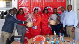 File image of Pauline Sheghu, Linet Ayuko and officials from Farmers Choice