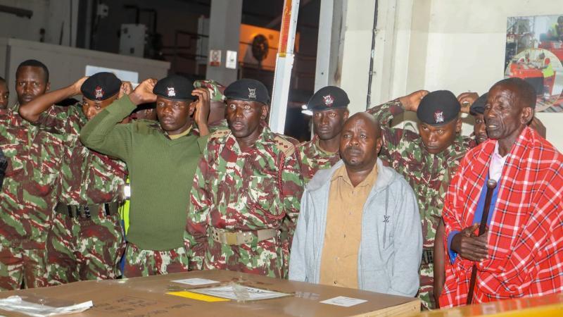 File image of Samuel Tompoi's family and police officers at JKIA