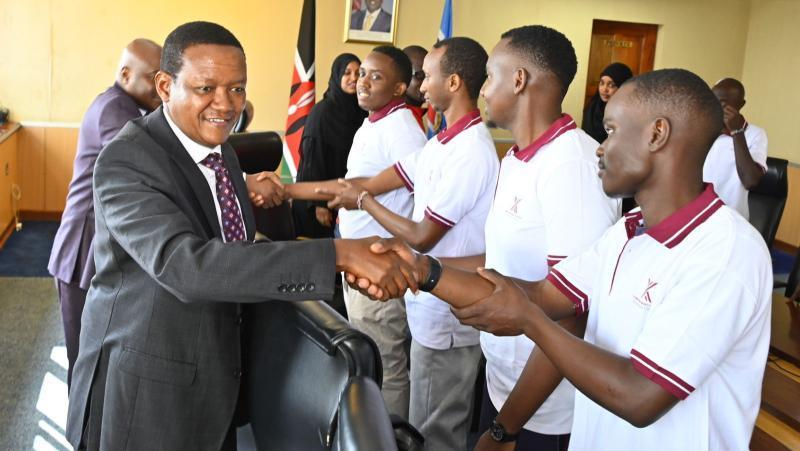 File image of Labour Cabinet Secretary Alfred Mutua with Kenyans heading to Russia