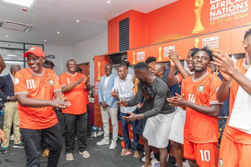 President William Ruto with Harambee Stars players at the dressing room after their win against DR Congo.