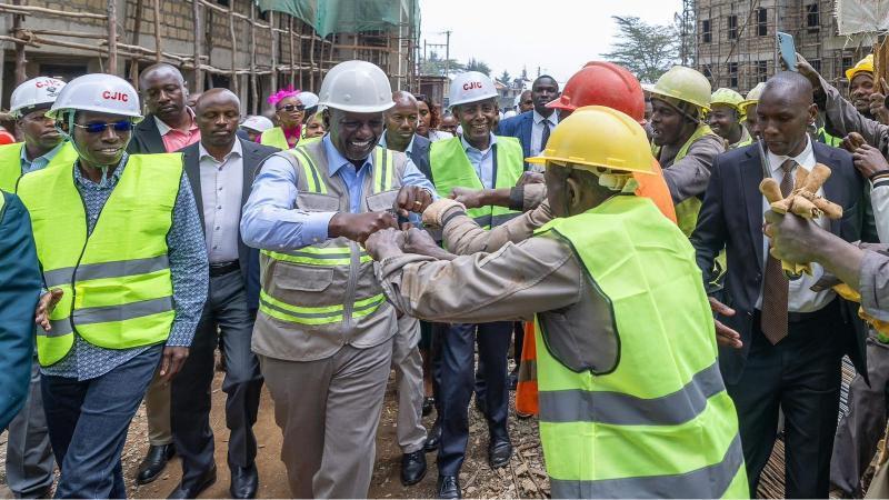 File image of President William Ruto interacting with construction workers