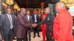 File image of President William Ruto interacting with Harambee Stars Captain Aboud Omar