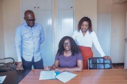 File image of Linda Bach, signing her new contract as KEG CEO alongside KEG President Zubeidah Koome.