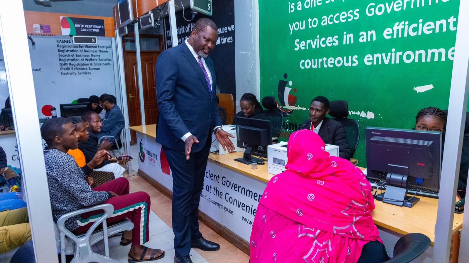 File image of Public Service Cabinet Secretary Geoffrey Ruku interacting with Huduma Centre employees