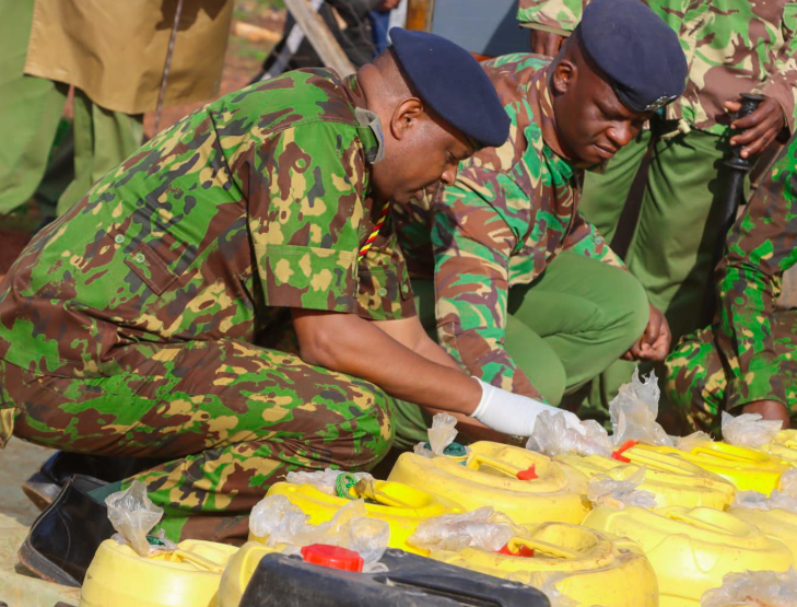 Police during a crackdown on chang'aa dens.