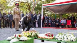 File image of President William Ruto laying a flower at Raila Odinga's gravesite