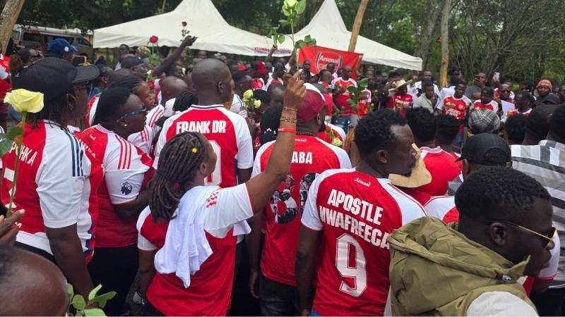 File image of Arsenal fans at Raila Odinga's gravesite in Bondo