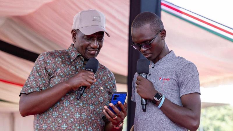 File image of President William Ruto interacting with a NYOTA Fund beneficiary