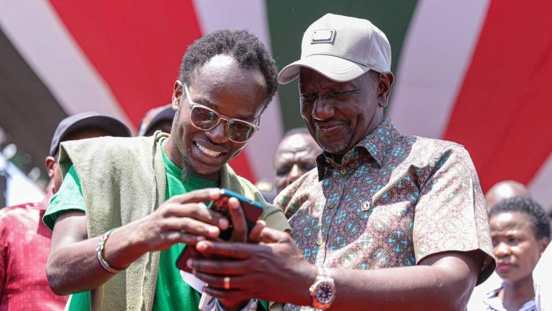 File image of President William Ruto with a NYOTA Fund beneficiary