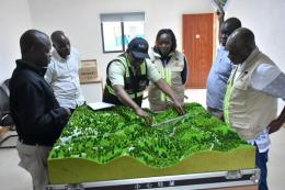 KeNHA officials, led by DG Luka Kimeli, inspect the design of the proposed new Nithi Bridge.
