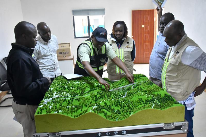 KeNHA officials, led by DG Luka Kimeli, inspect the design of the proposed new Nithi Bridge.