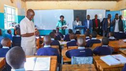 File image of Basic Education Principal Secretary John Ololtuaa interacting with pupils