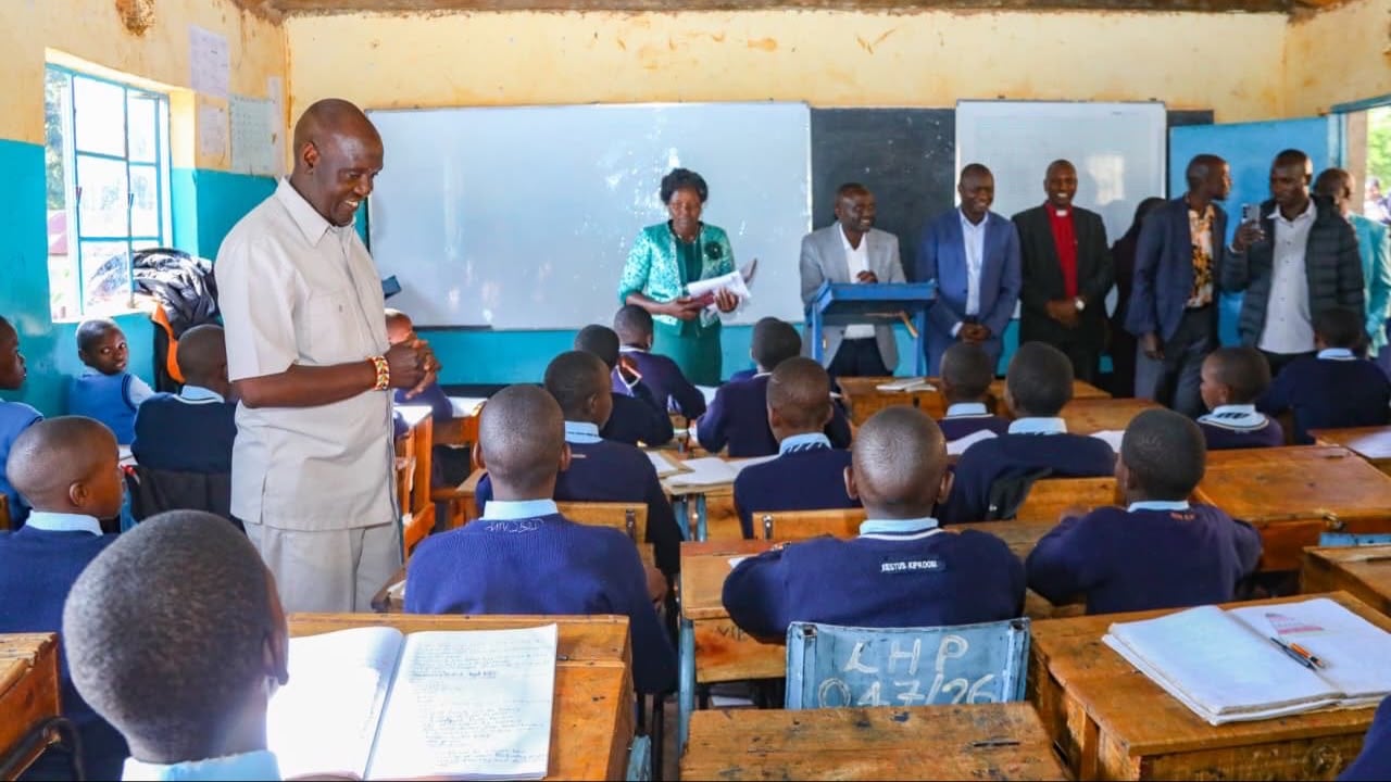 File image of Basic Education Principal Secretary John Ololtuaa interacting with pupils