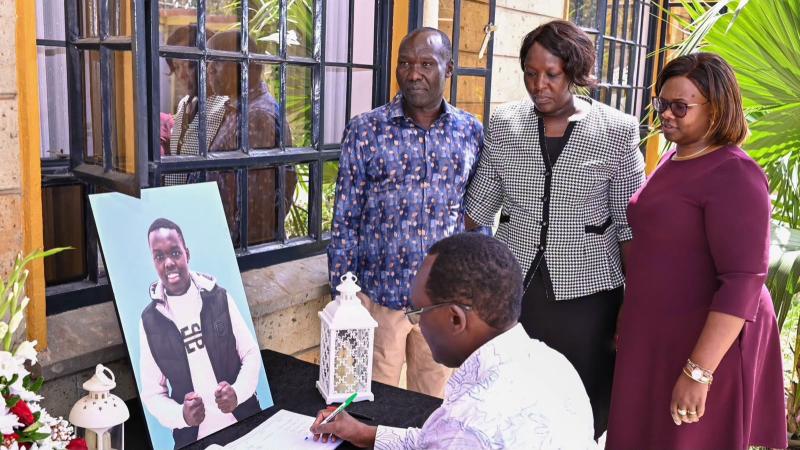 File image of Treasury Principal Secretary Chris Kiptoo signing the condolence book at Fred Segor's home