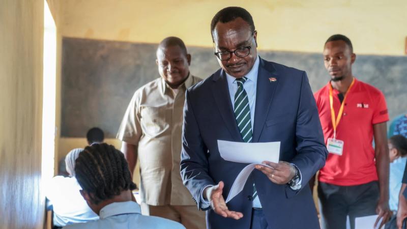 File image of Education Cabinet Secretary Julius Ogamba distributing tests